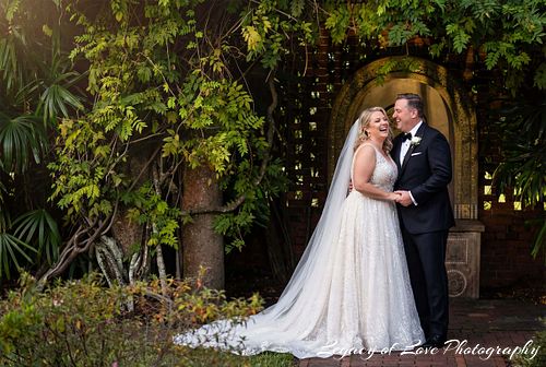 Bride and groom embracing in the gardens at Cummer Museum of Art & Gardens in Jacksonville
