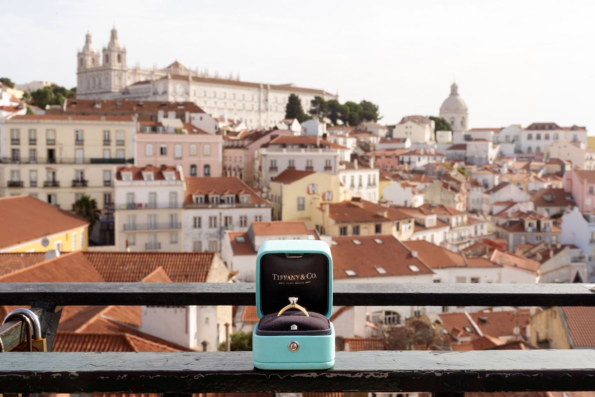 Open engagement ring box overlooking Alfama in Lisbon