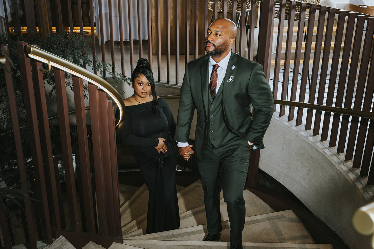 Couple in formal attire on a curved staircase during a Medellin engagement shoot
