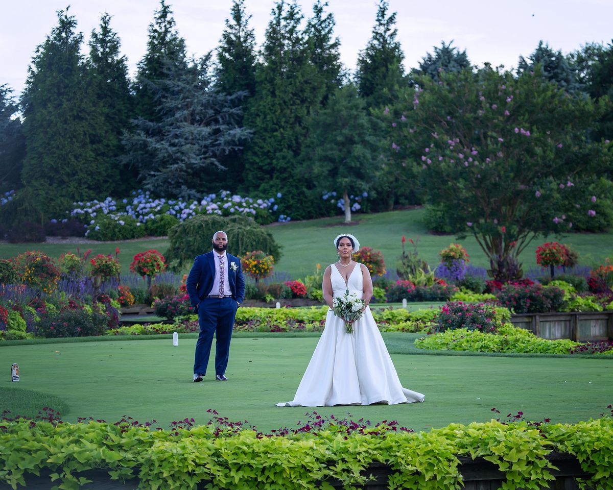 bride and groom posing on the greens at baywood