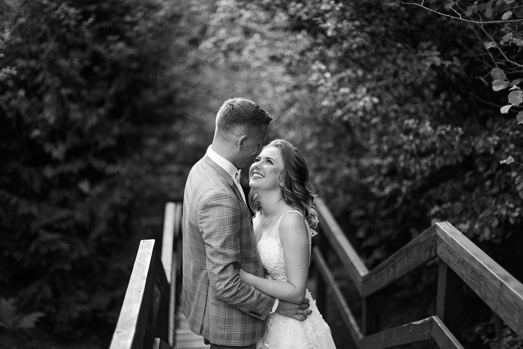 Bride and groom walking together on a wooden bridge in Ukraine