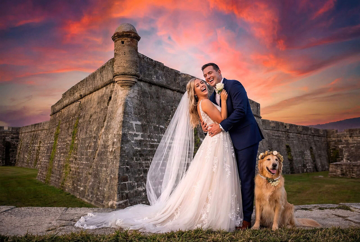 Bride and groom with their dog at sunset outside Castillo de San Marcos, St. Augustine wedding photography by Legacy of Love Photography.