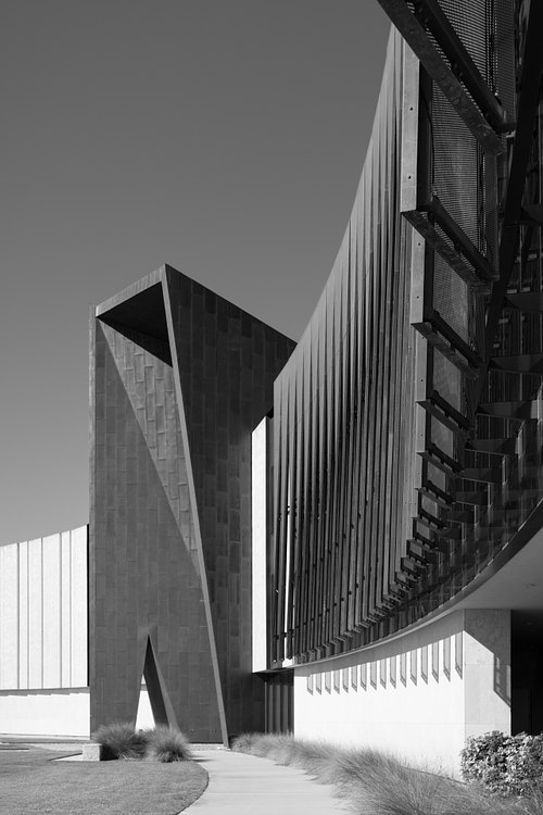 Low-angle black and white architectural photograph emphasizing the bold geometric lines, shadows, and contemporary design elements on the Daytona State College campus.
