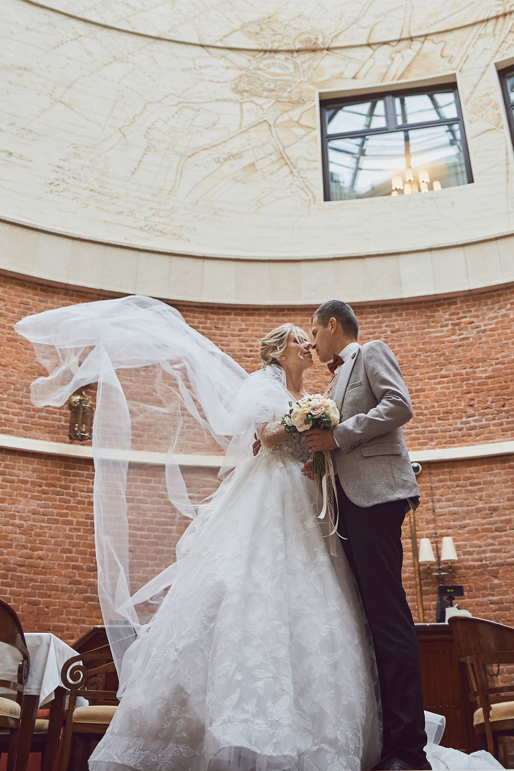 Bride and groom kissing beneath a flowing veil at Citadel Inn