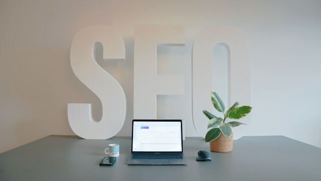 home workspace with an SEO behind the laptop