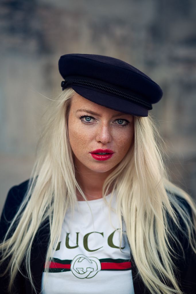 Close-up portrait of a woman in a black cap