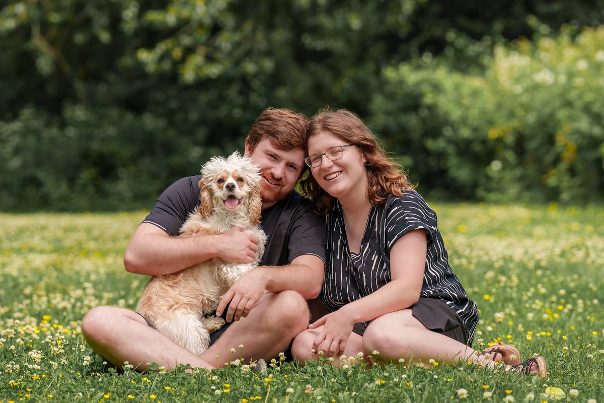 Family photo with pet cocker spaniel at the park.