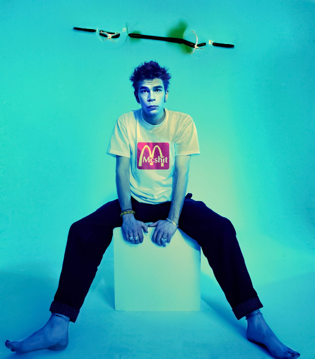 A portrait of celebrity Dylan Lewis in Sydney. He wears a McDonald's McShit T-shirt.