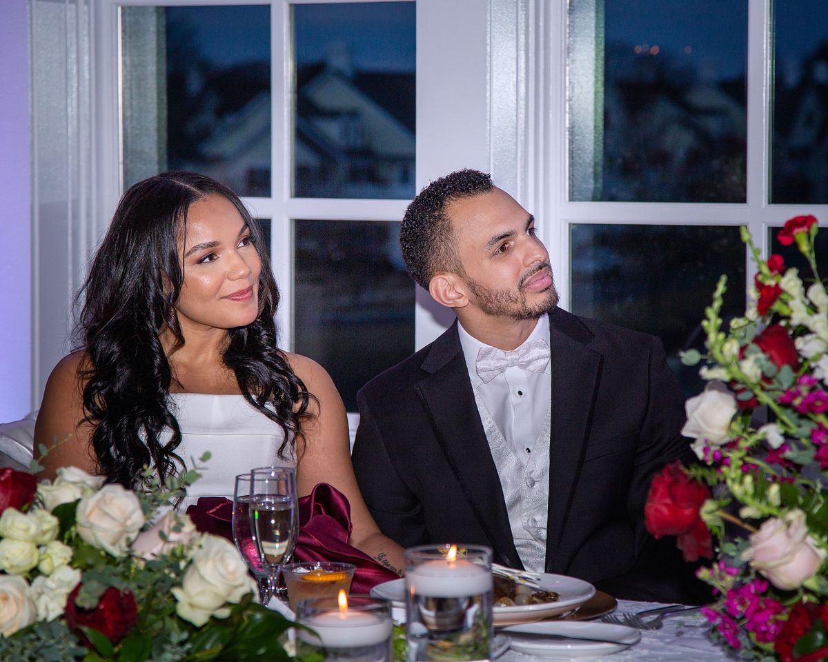 bride and groom listening to speeches in the ball room at baywood