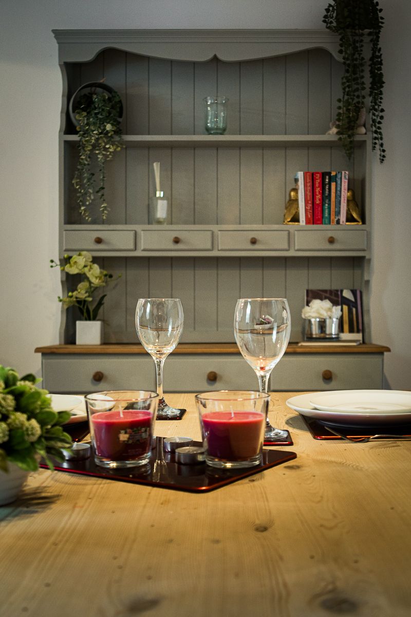 Dining area in a holiday cottage with wine glasses and table setting