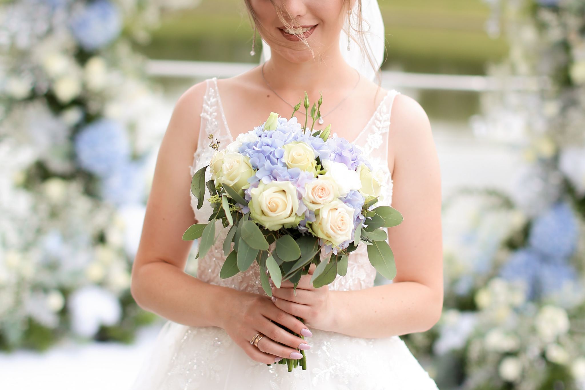 Bride holding a blue and white wedding bouquet in Ukraine
