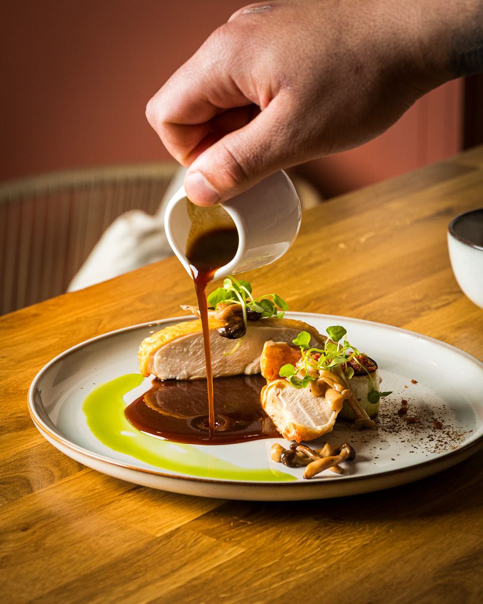 Gravy is poured onto a dish of chicken fillets