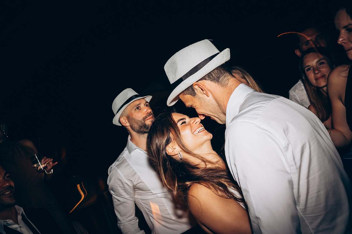 Wedding guests dancing together during the evening celebration