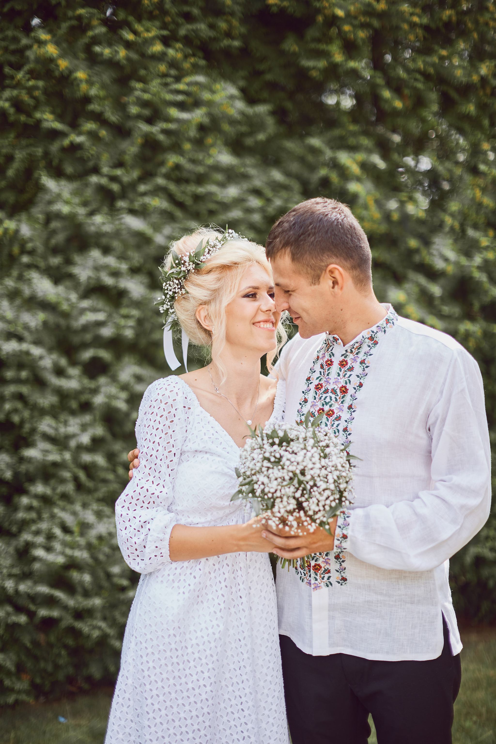 Bride and groom embracing outdoors