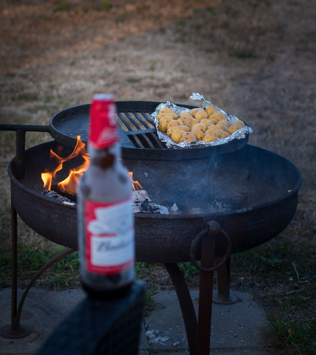 Fire pit with food as part of a glamping experience photography