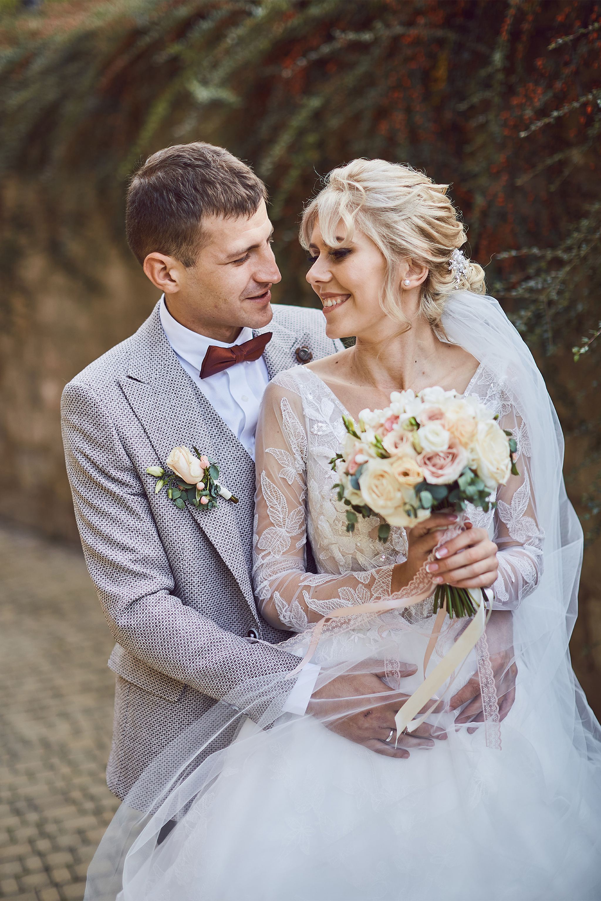 Bride and groom smiling together during their wedding portraits
