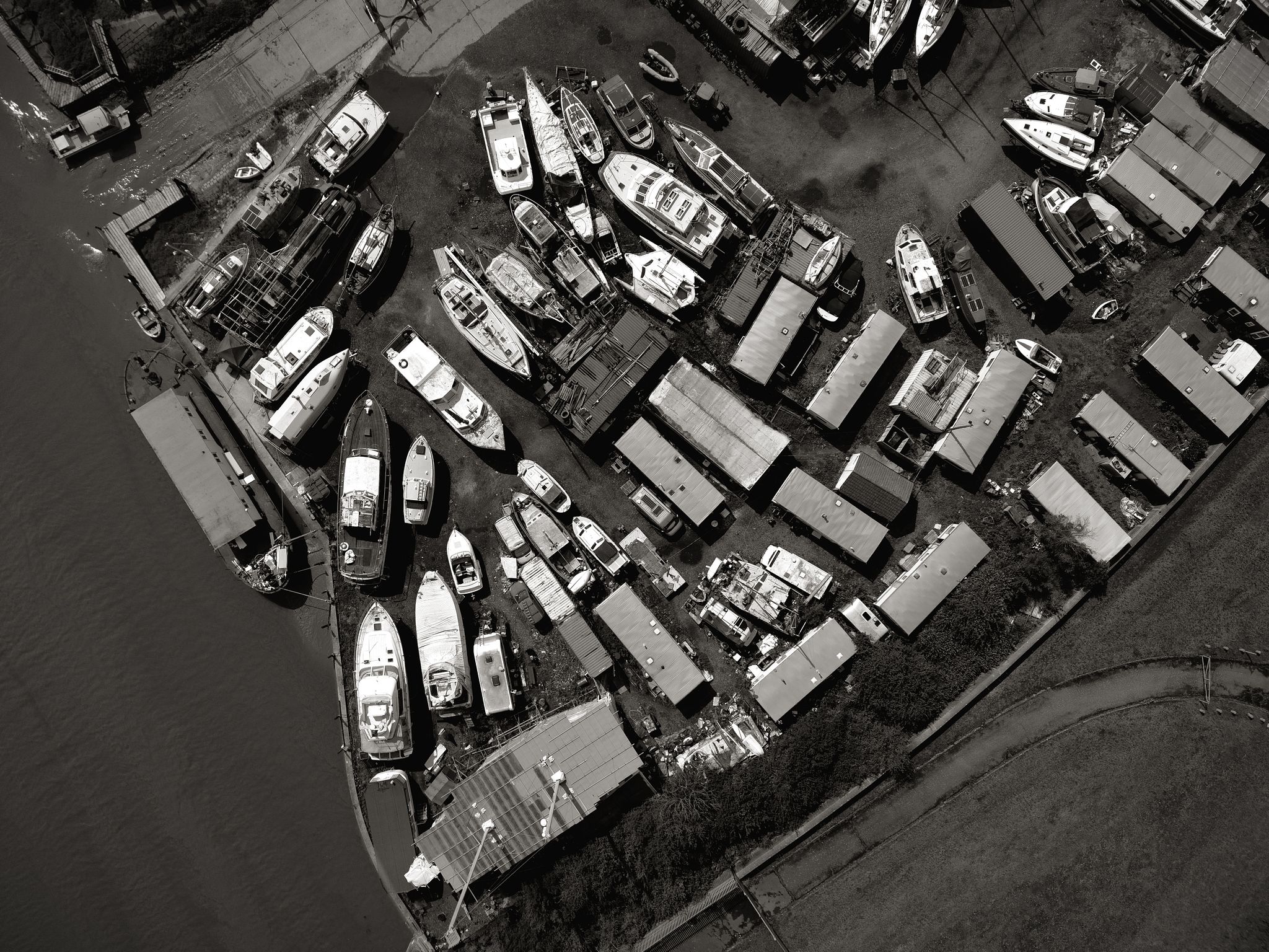 Black and white aerial photograph of the boatyard and moored boats at Benfleet, Essex, viewed directly from above.