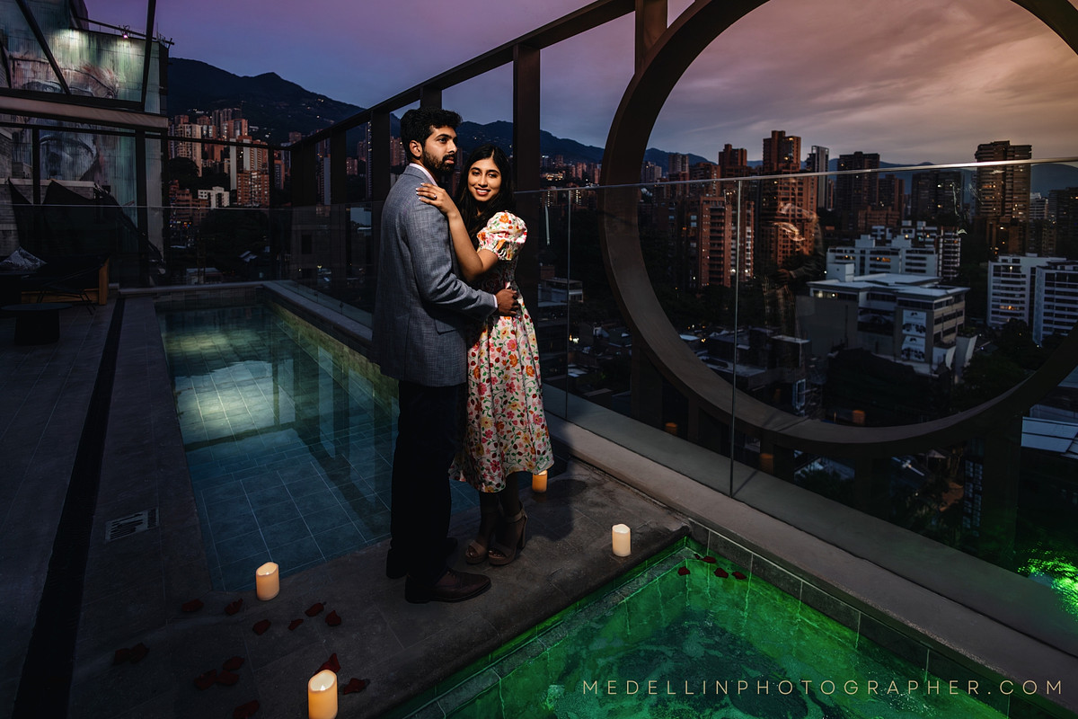 Sunset rooftop engagement portrait above the Medellin skyline