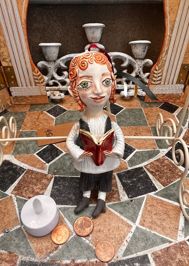 Traditional boy with a book, little ceramic hanging sculpture