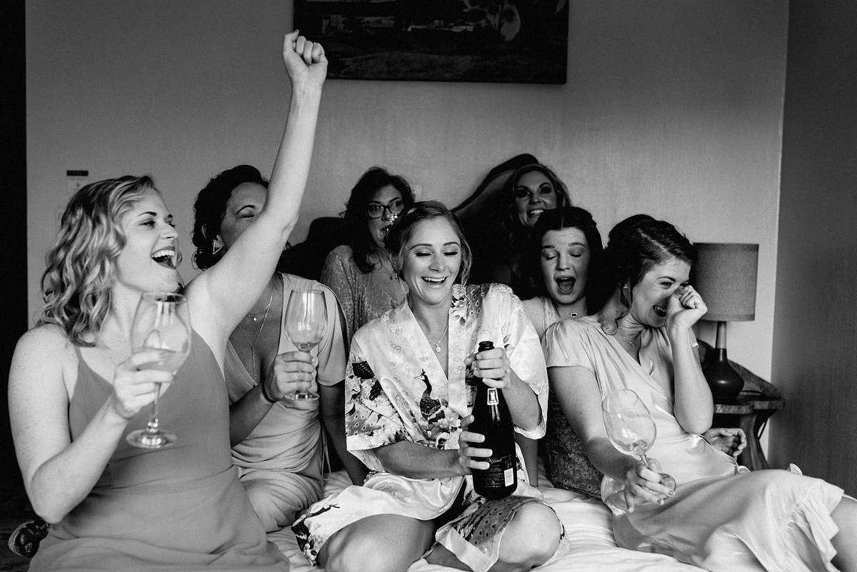 Bride laughing with bridesmaids in Costa Verde
