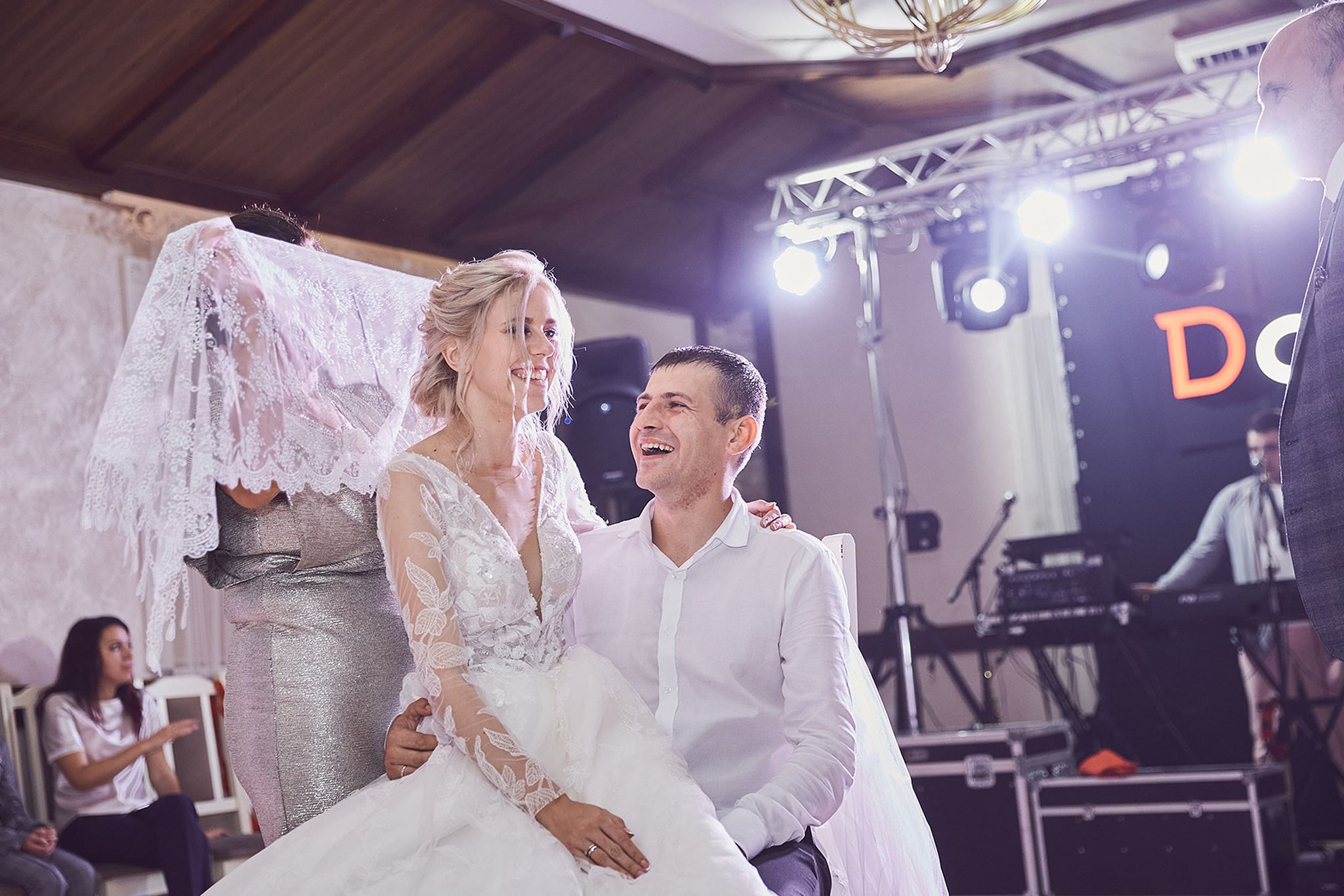 Bride and groom with flowing veil during their wedding portraits