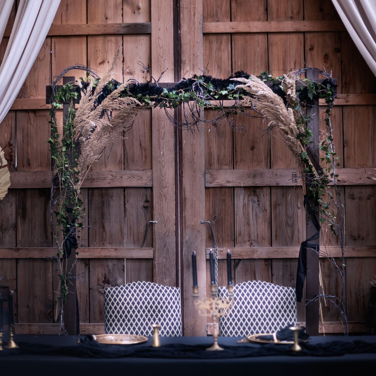 barn decorations, sweetheart table inside the barn at cohee barn wedding venue, the colors are warm browns and greens.