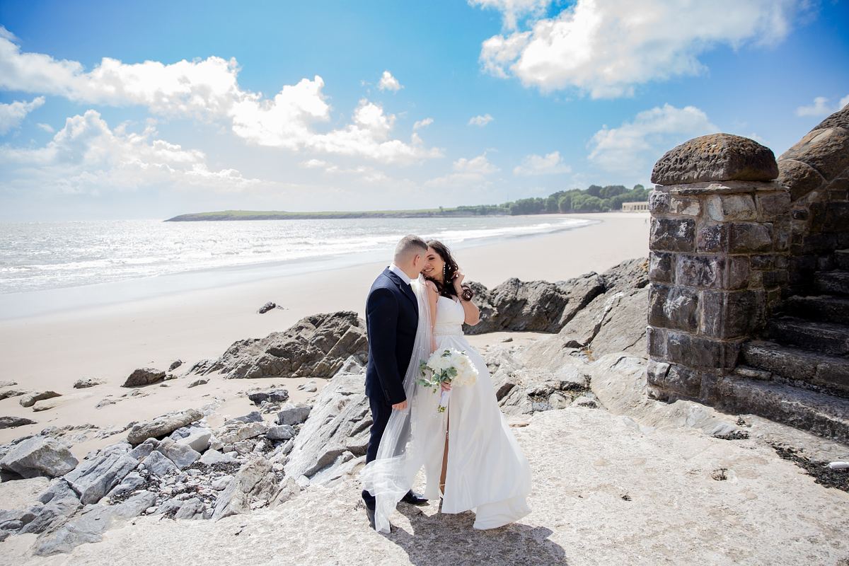Bride and groom by the coast at Barry Island, South Wales