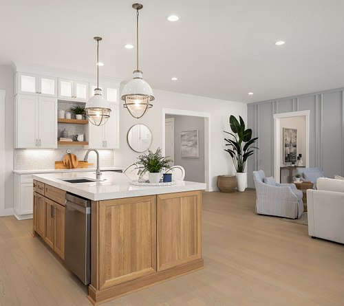 Professional interior photography of a modern luxury kitchen in a Mastercraft Builder Group home, featuring a large kitchen island, and contemporary finishes.