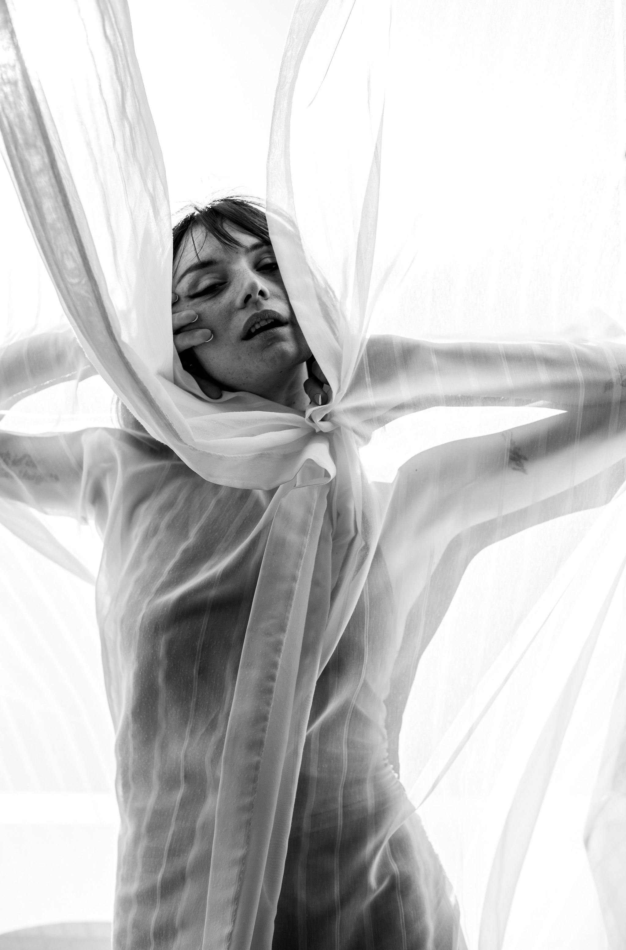 Beautiful Latvian model posed behind curtain at the Chateau Marmont by portrait photographer in Copenhagen