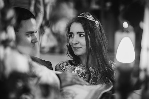 Stylish emotional bride and groom making oaths and holding hands