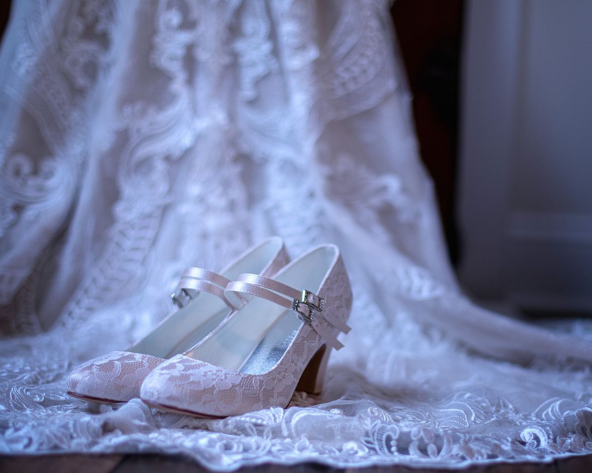 detail shot of laced shoes on laced dress