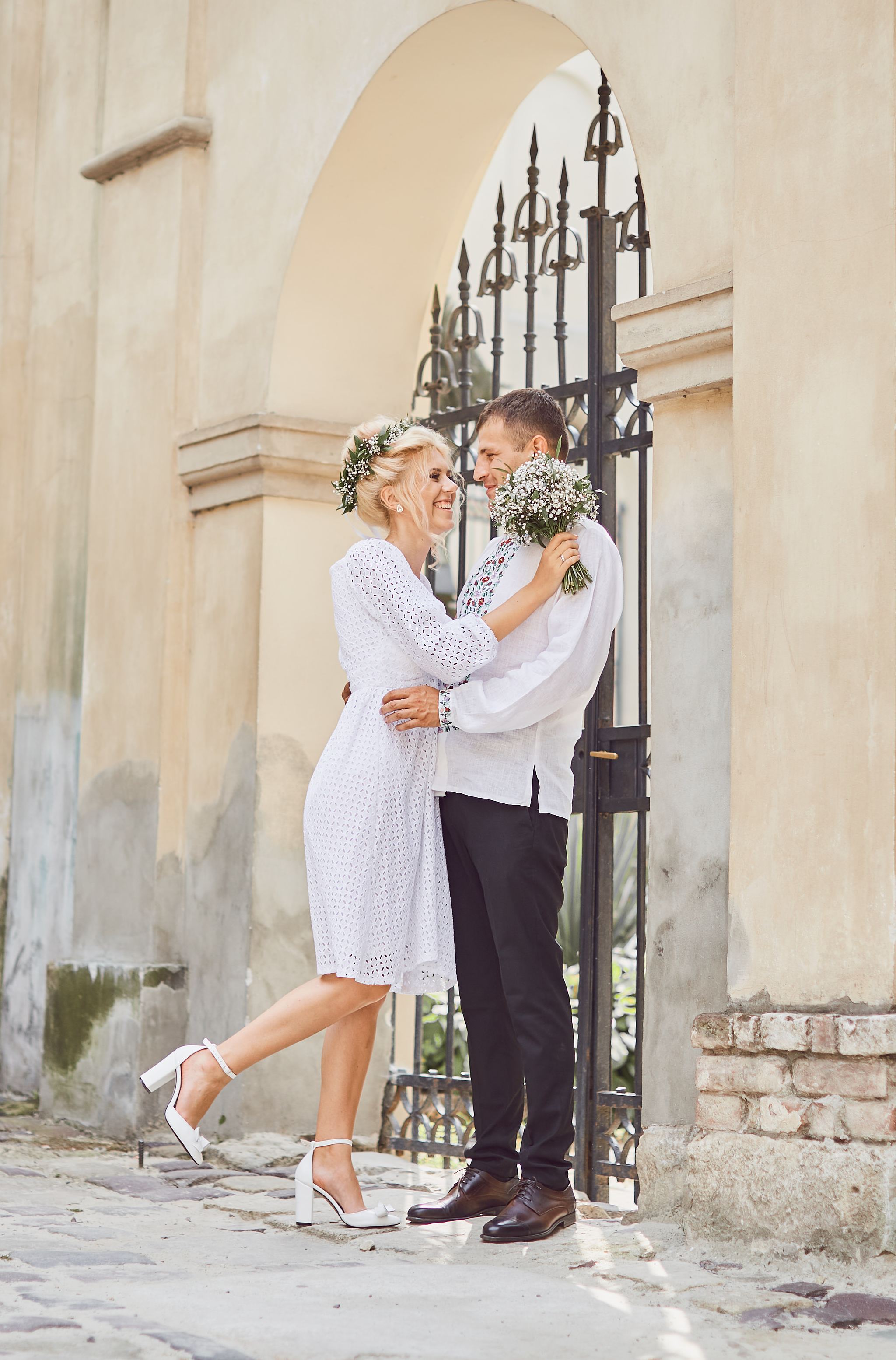 Bride and groom smiling together on the street