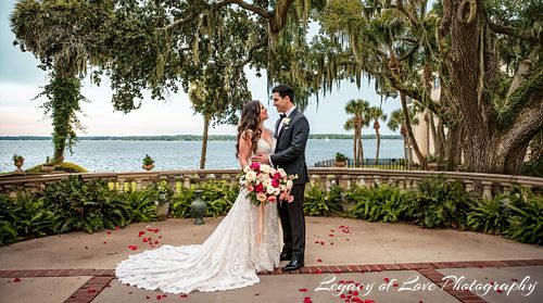 Bride and groom sharing a romantic moment beneath an oak tree at a Jacksonville Club Continental