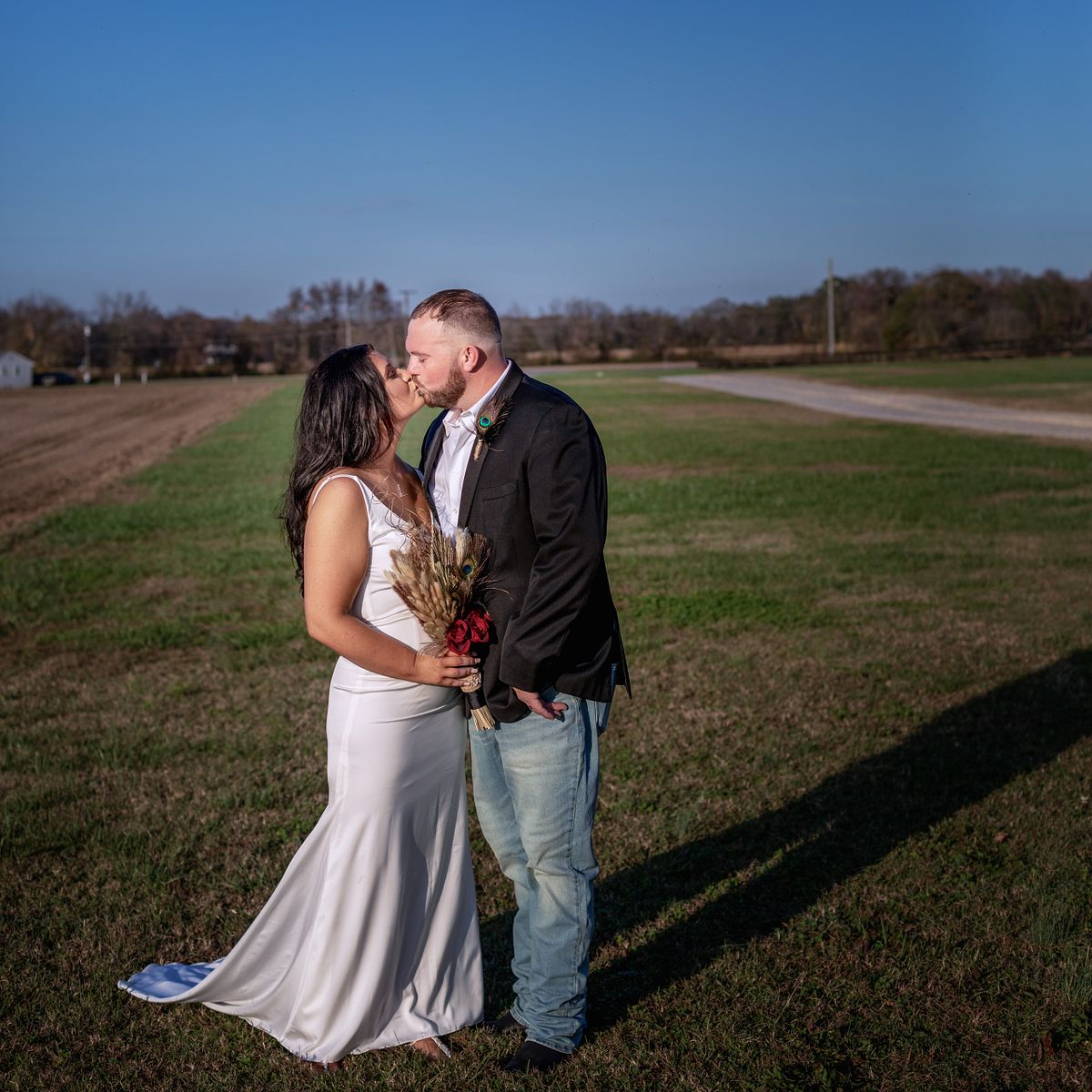 bride and groom kissing on the front lawn at cohee farm wedding venue in hurlock, md