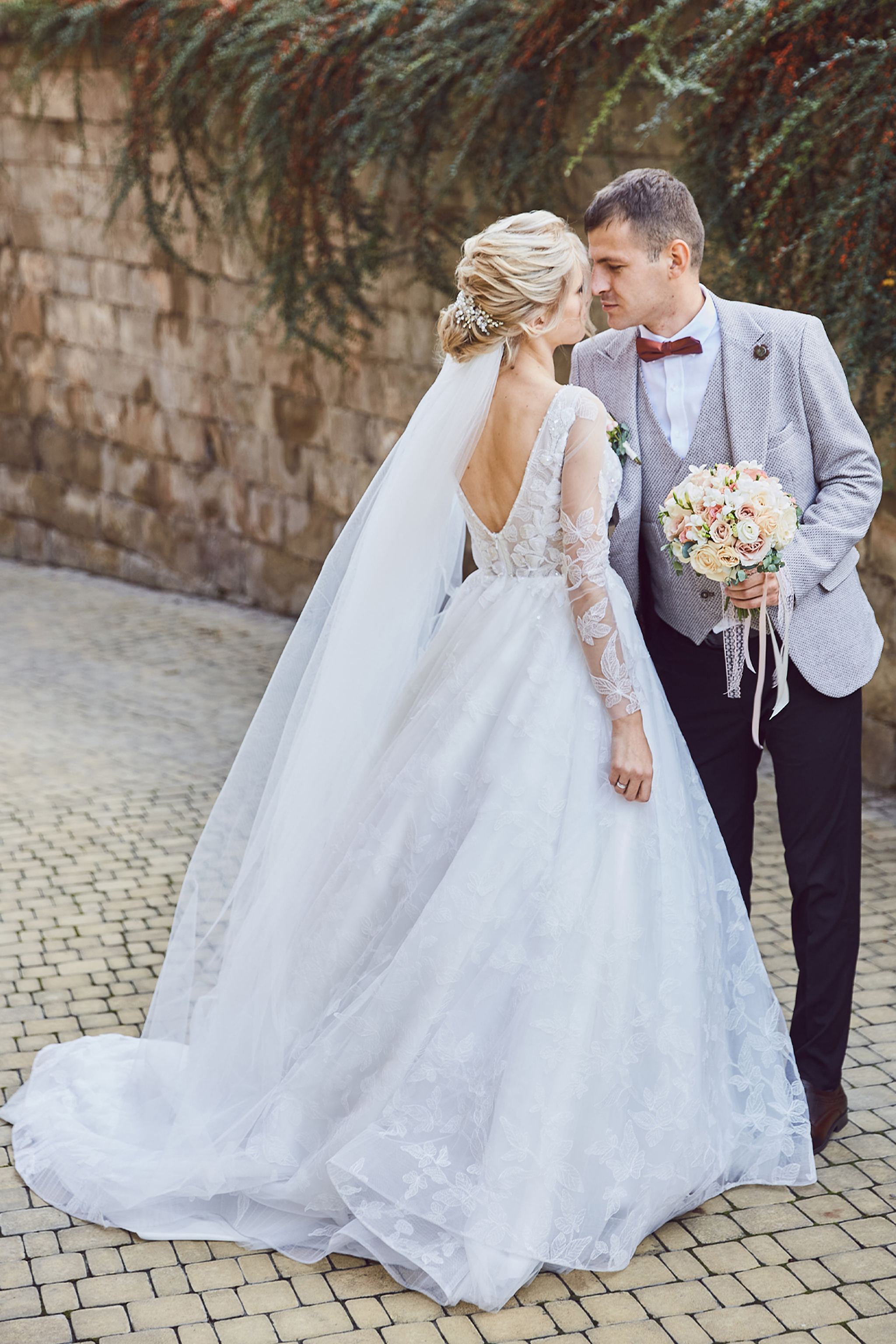 Bride holding white balloons during her wedding day