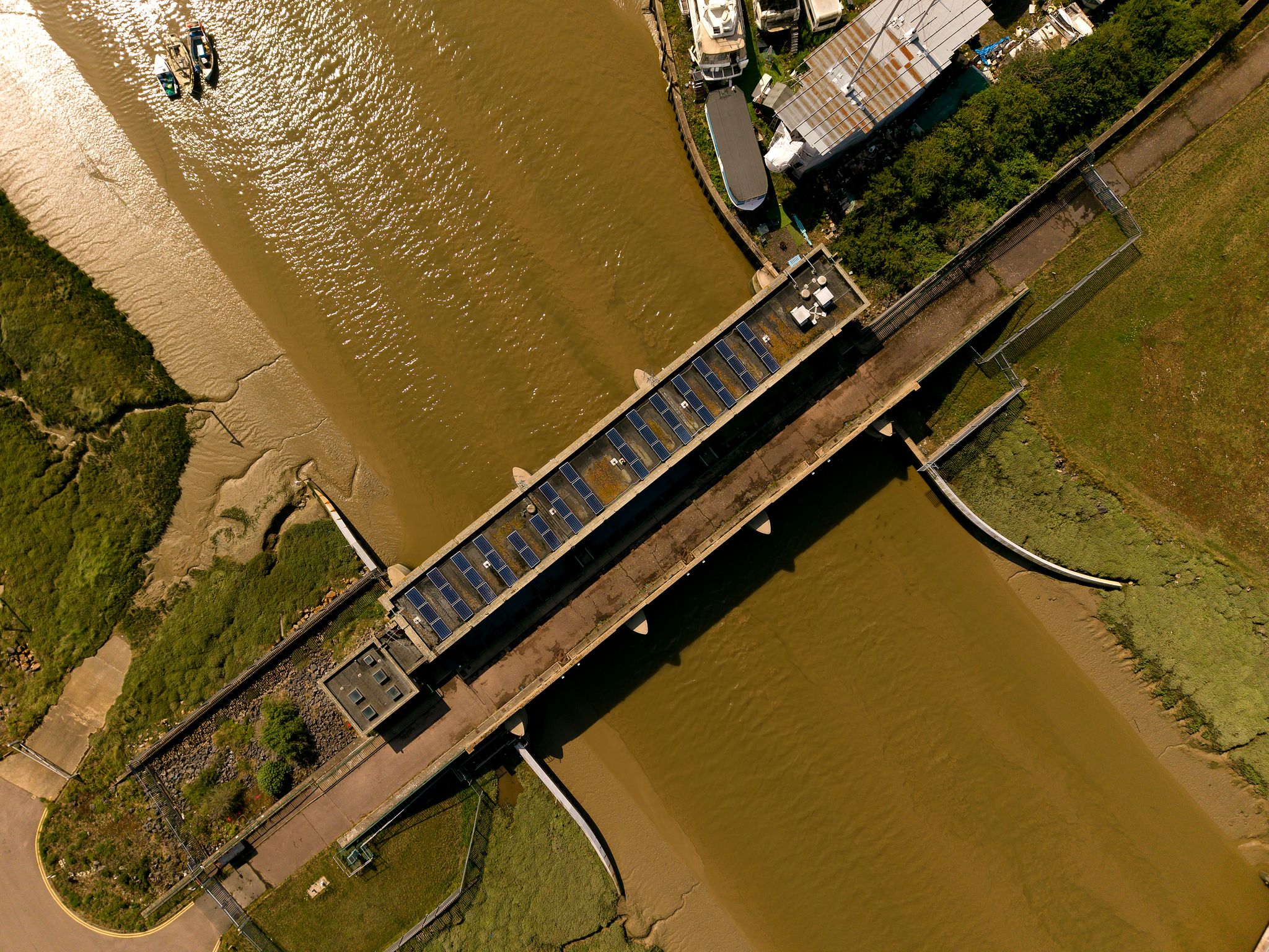 Aerial photograph of a Benfleet bridge crosing the tidalestuary and saltmarsh in Essex, viewed directly from above.