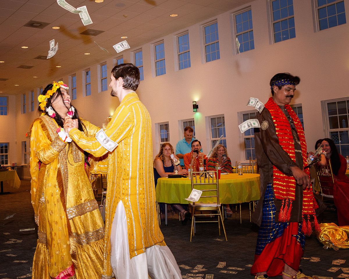 Mehndi reception bride and groom wearing gold garments documented with natural light photography