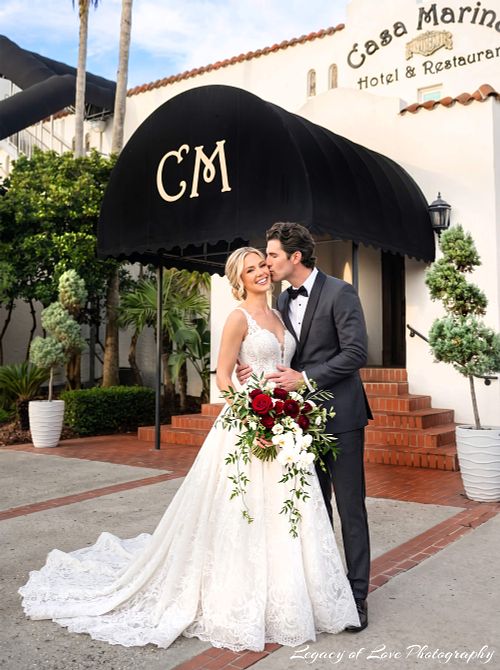 Bride and groom posing outside Casa Marina Hotel in Jacksonville Beach, Florida after their wedding