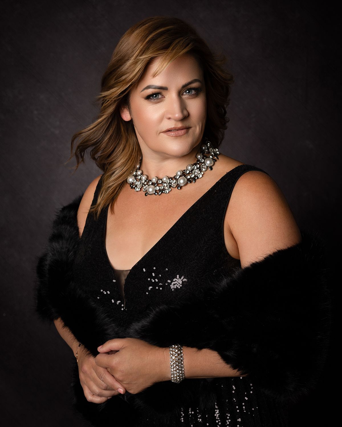luxury glamour portrait of a woman over 40 in an evening gown