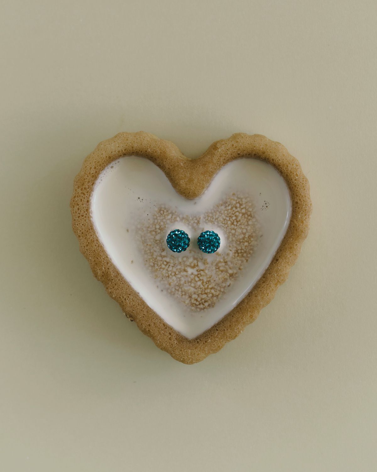 Editorial photo of Swarovski earrings placed in a composition with milk. Photographed by Filianna Karamanli.
