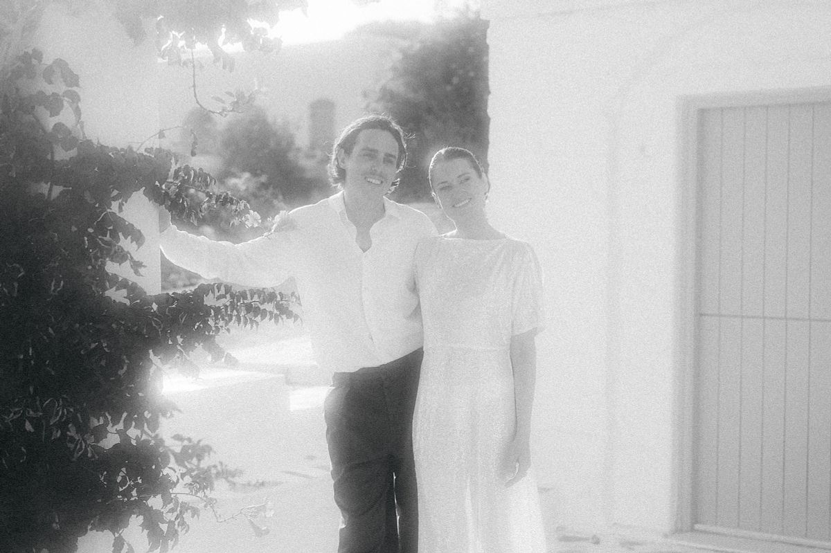 romantic wedding couple in Serifos Cyclades Greece with traditional white houses background &ndash; destination wedding photographer