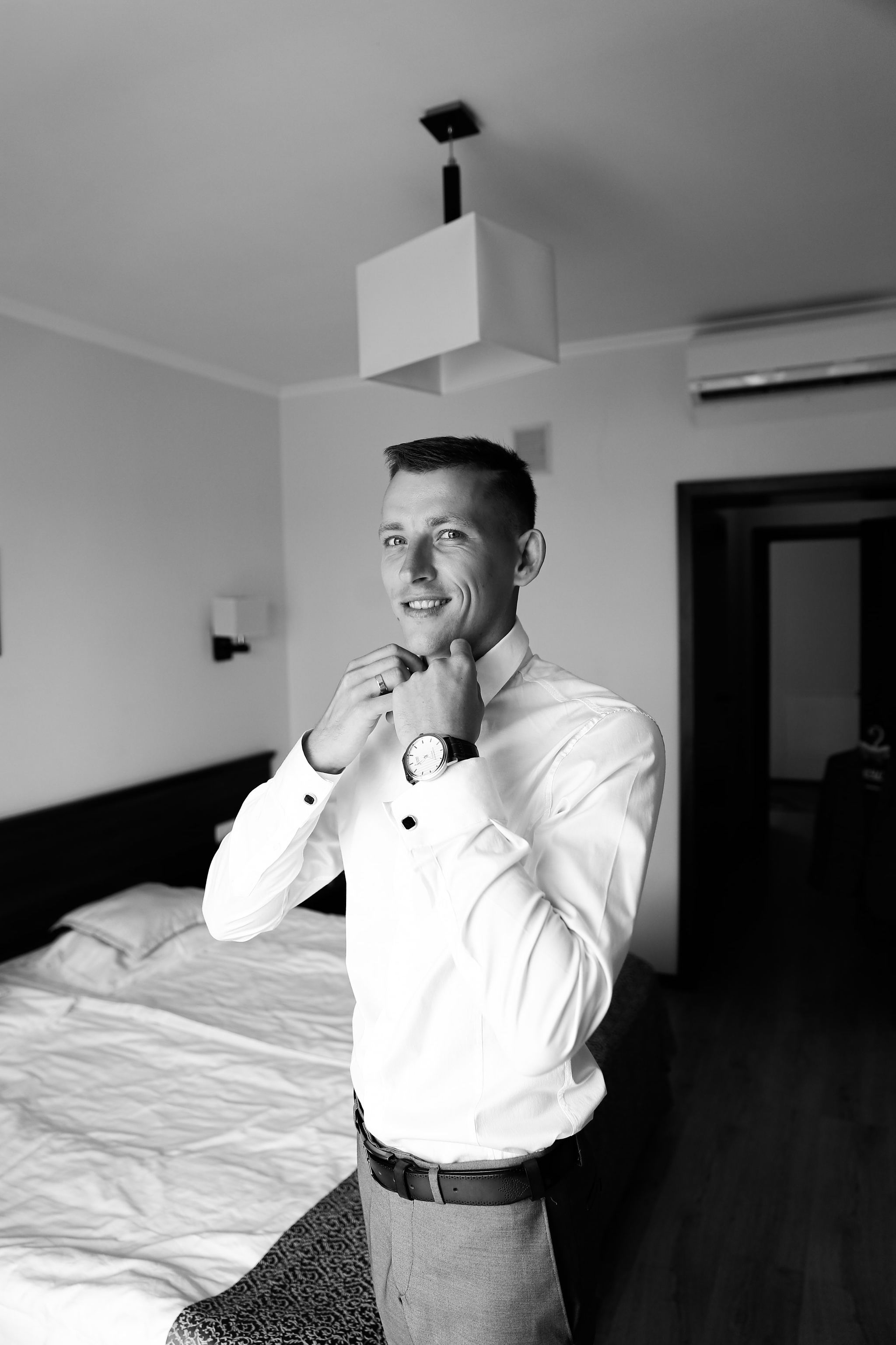 Black and white bridal portrait by the window before the wedding ceremony