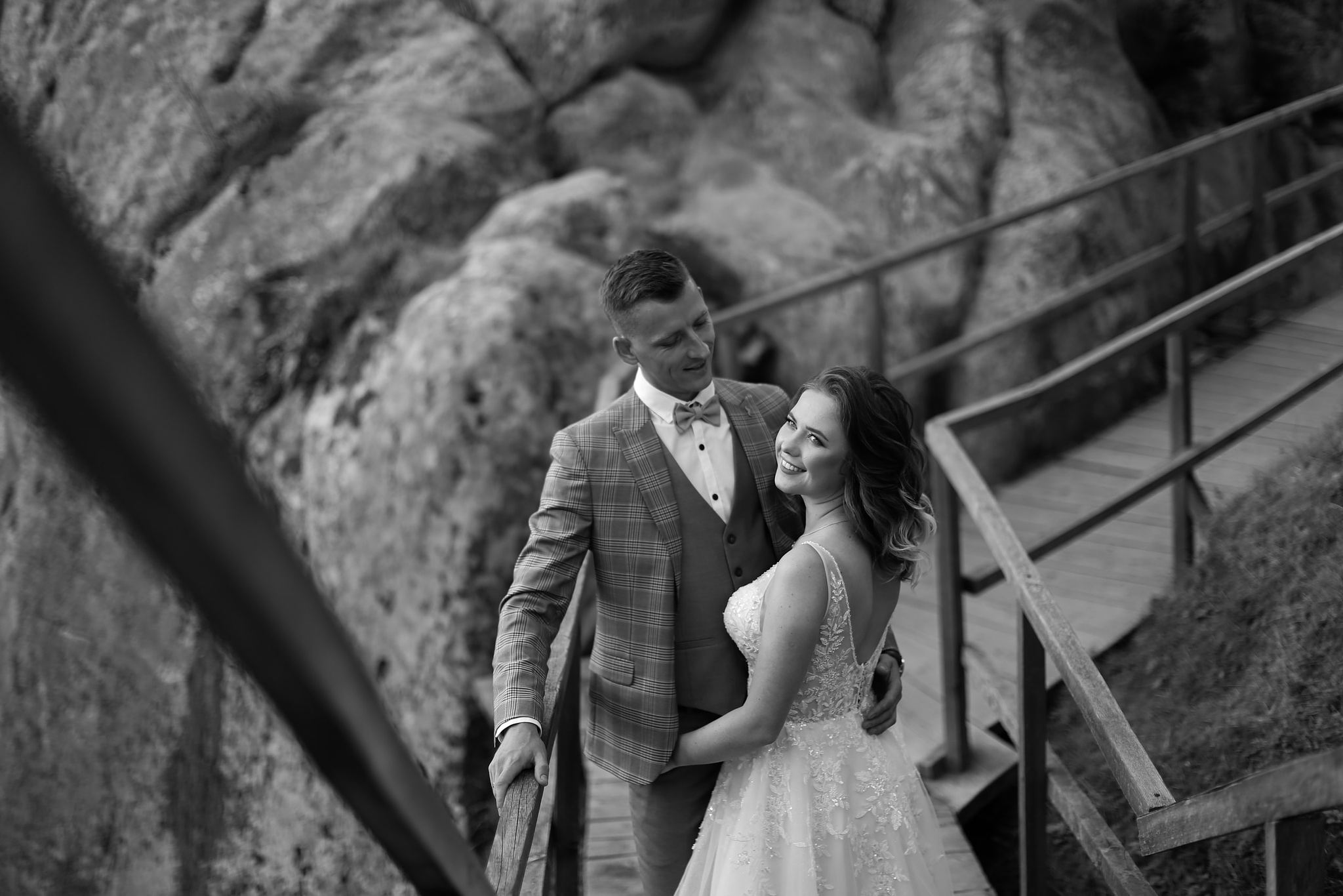 Bride and groom walking together on a wooden bridge in Ukraine