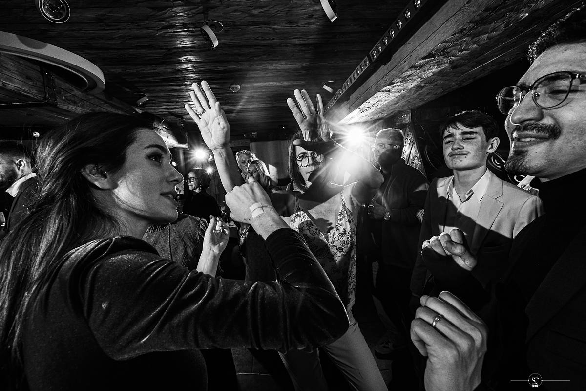 Cocktail et Soir&eacute;e de Mariage avec les invit&eacute;s et les mari&eacute;s qui s'amusent, sourient, s'embrassent et dansent. Les Rhodos La Clusaz Sebastien Clavel Photographe Mariage Lyon