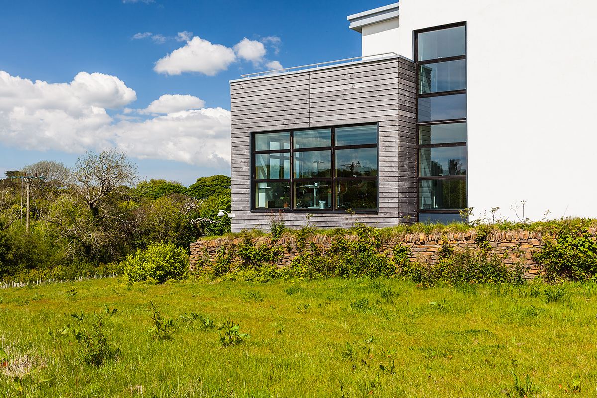 Architectural photograph of Tremough Innovation Centre in Cornwall, highlighting angled design and glass frontage.