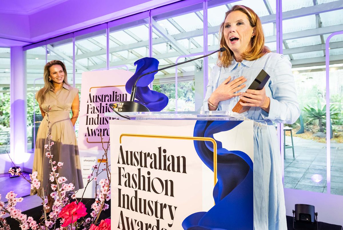 A recipient of an award at the Australian Fashion Industry Awards makes a speech on stage.