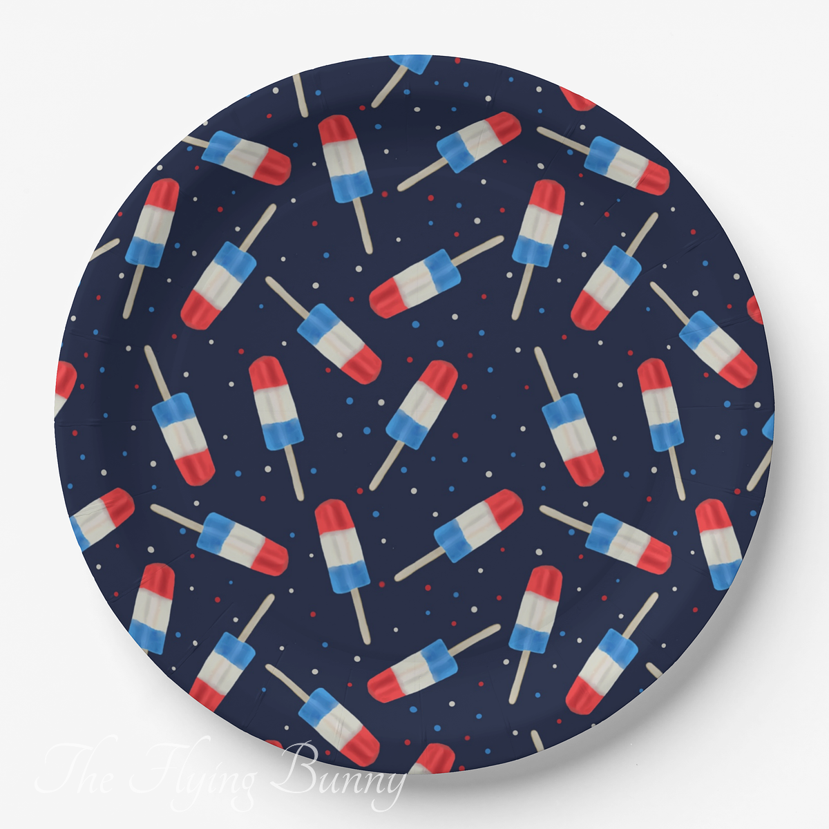Red, white and blue frozen ice treats in a repeating pattern on a navy background, shown on a round product mockup.