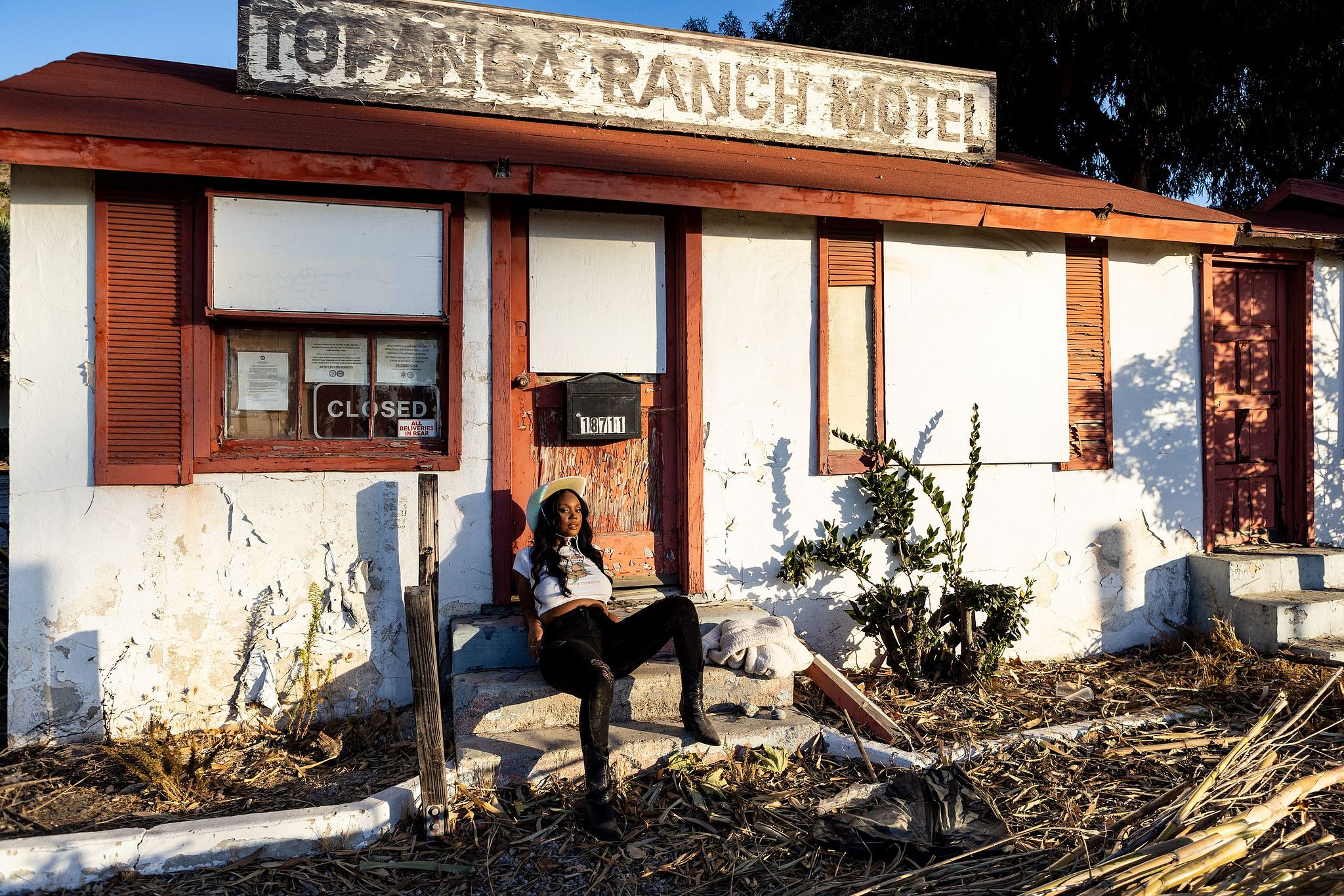 Black Cowgirl aesthetic beautiful model lounges on Topanga Canyon Ranch Motel by copenhagen portrait photographer