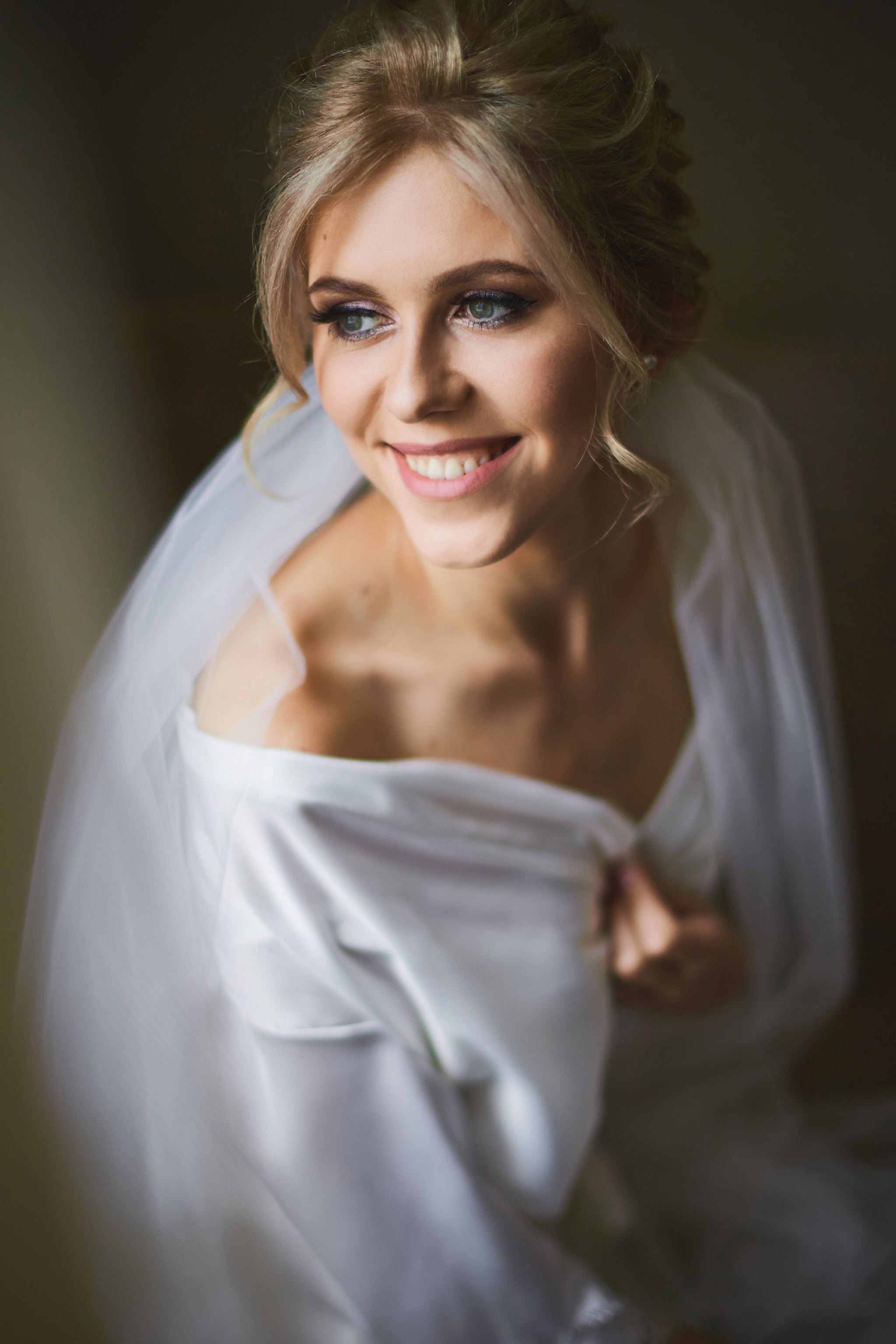 Smiling bride in a softly lit bridal portrait