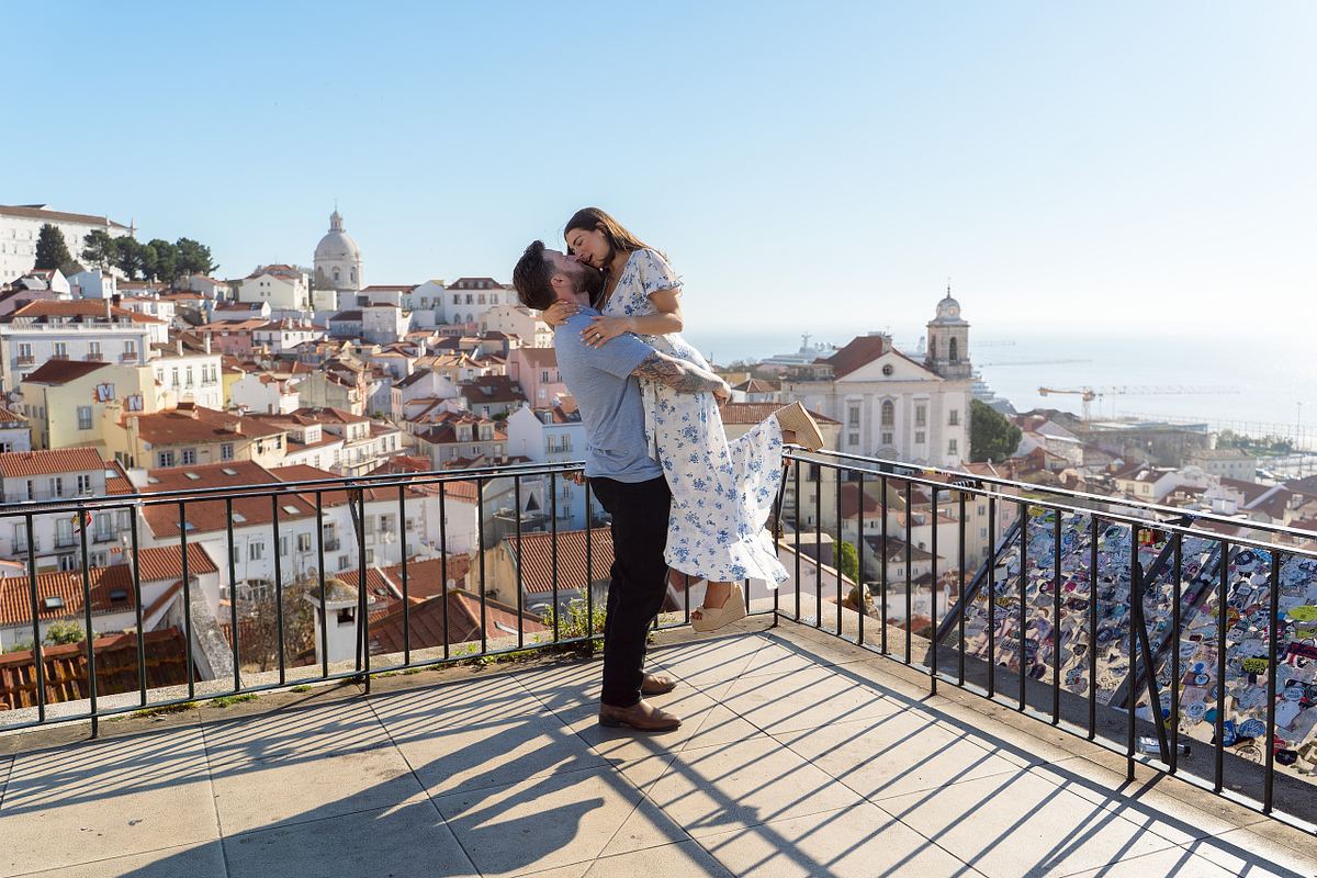Newly engaged couple celebrating their proposal overlooking Lisbon